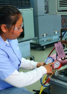 Female student working on air conditioner