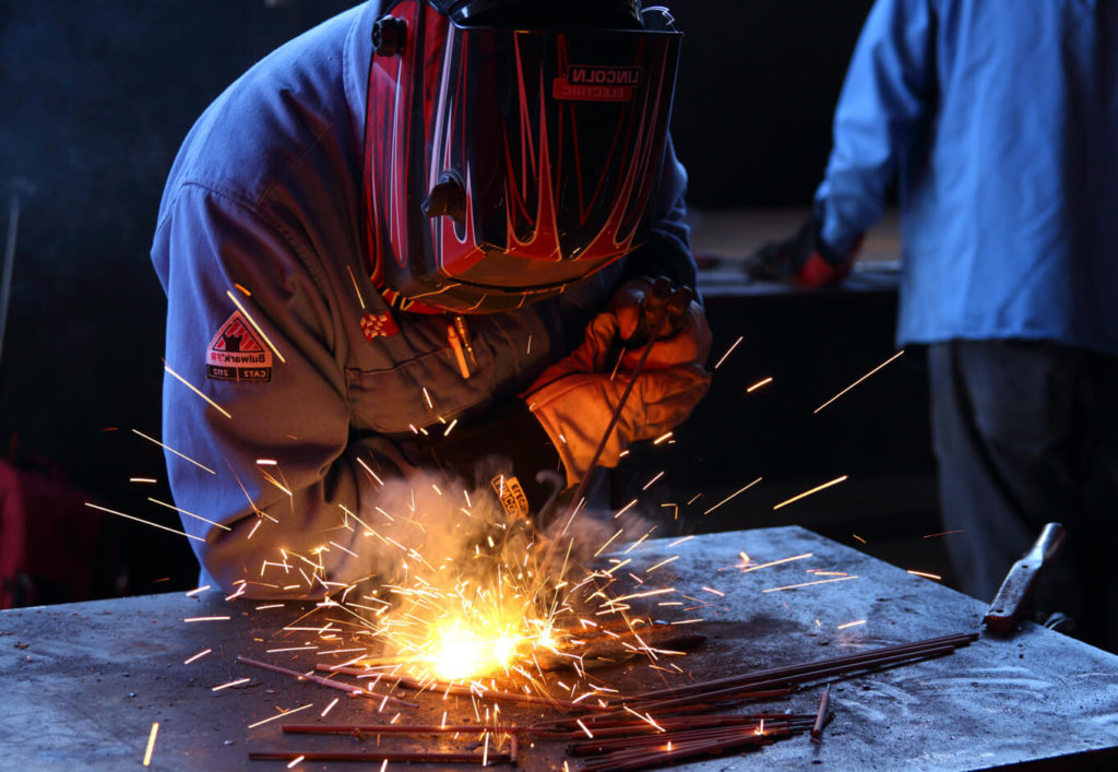 a student welding in the welding program at AAI